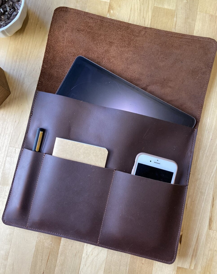 This sleek full grain leather sleeve is made to fit tablets that are 12” x 8.75” x .5”   Extra pockets will carry your field notes and a phone up to 3” wide.  Water resistant and Provides protection from minor falls.  Personalize it and complete the perfect gift!  Made in Austin, Texas