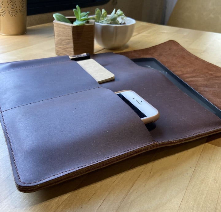 This sleek full grain leather sleeve is made to fit tablets that are 12” x 8.75” x .5”   Extra pockets will carry your field notes and a phone up to 3” wide.  Water resistant and Provides protection from minor falls.  Personalize it and complete the perfect gift!  Made in Austin, Texas