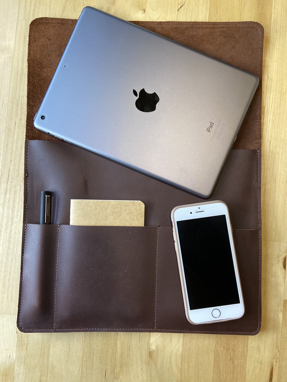 This sleek full grain leather sleeve is made to fit tablets that are 12” x 8.75” x .5”   Extra pockets will carry your field notes and a phone up to 3” wide.  Water resistant and Provides protection from minor falls.  Personalize it and complete the perfect gift!  Made in Austin, Texas