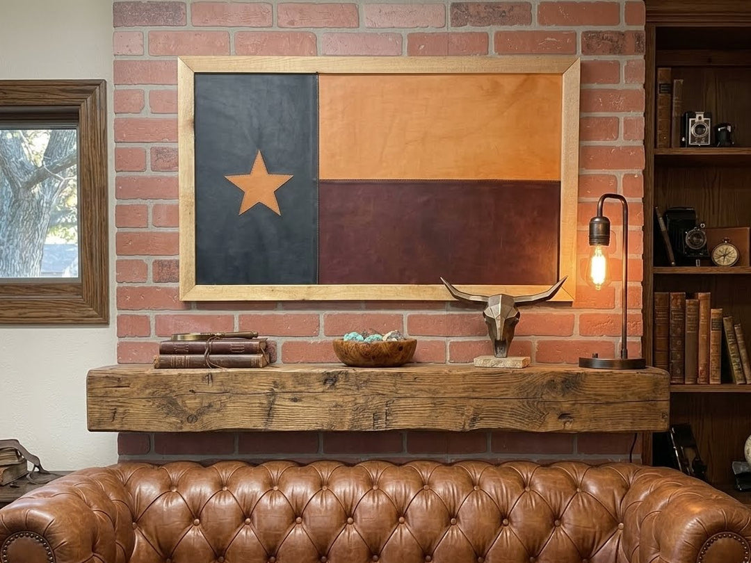 Brown leather sofa in front of a brick wall with a framed Texas flag, bull skull, and books.