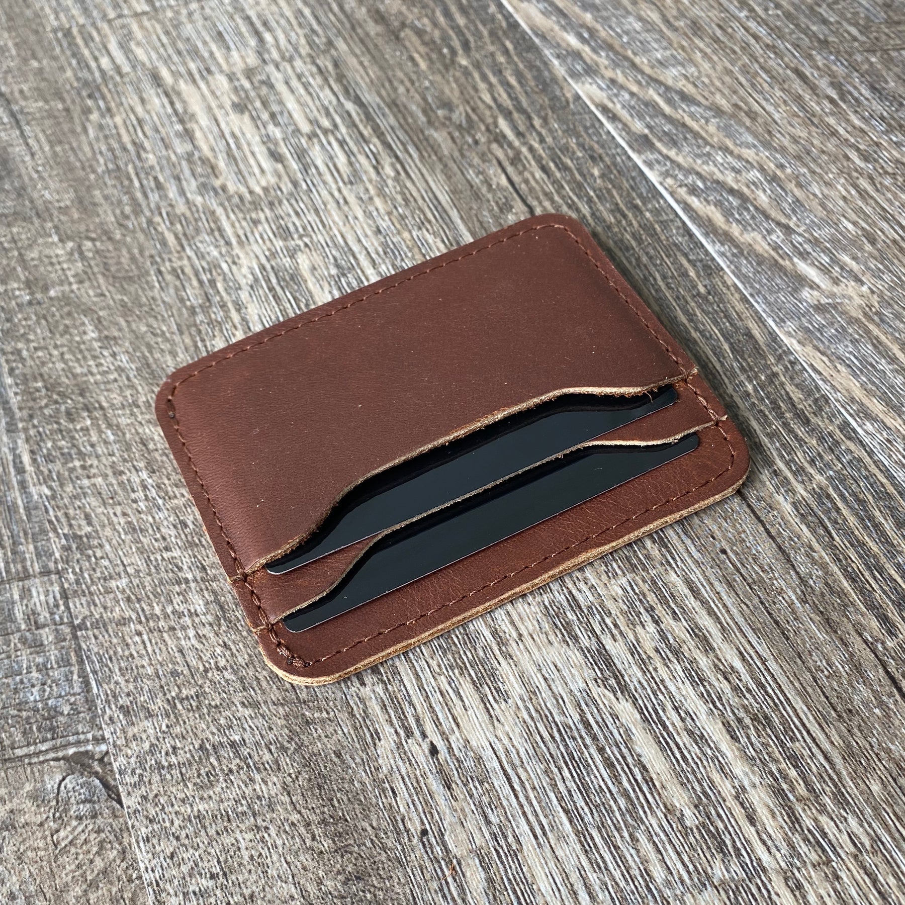 Handmade Black leather wallet with Cuadra's monogram appliqué