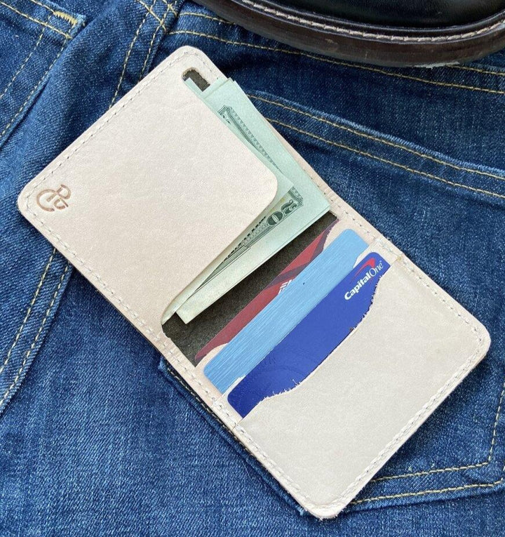 Made with a premium full grain veg tan interior and a gorgeous full grain turquoise exterior.  Stitched with thick vibrant red thread that complements the beautiful turquoise.  This minimalist and slim wallet holds 5+ cards and cash.  Handmade in Austin, Texas!